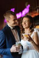 bride and groom inside a cocktail bar photo