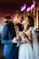 bride and groom inside a cocktail bar photo