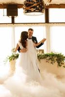 the first dance of the bride and groom inside a restaurant photo