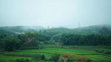 The beautiful countryside view from the runny train on the south of the China in the rainy day photo