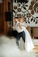 the first dance of the bride and groom inside a restaurant photo