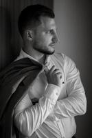 portrait of smiling groom with beard photo