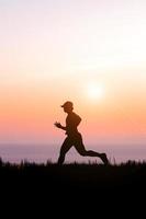 people jogging in the meadow in the evening photo