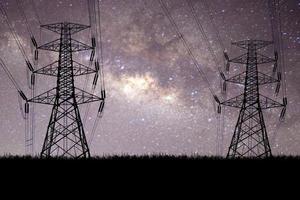 Silhouette of high voltage transmission towers with the beautiful Milky Way photo