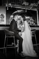 bride and groom inside a cocktail bar photo