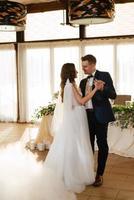 the first dance of the bride and groom inside a restaurant photo