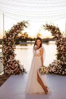 bride against the background of a yellow sunset photo