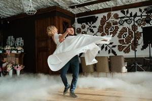 the first dance of the bride and groom inside a restaurant photo