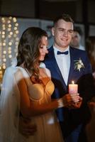 ceremony of handing over the wedding fire from parents to children with candles photo