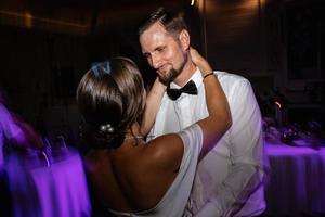 the first dance of the bride and groom inside a restaurant photo