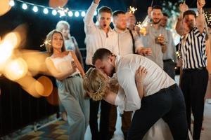 newlyweds at a wedding of sparklers photo