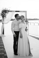 bride and groom against the backdrop of a yellow sunset photo