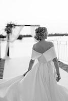 bride against the background of a yellow sunset photo