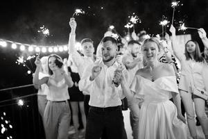 newlyweds at a wedding of sparklers photo
