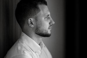 portrait of smiling groom with beard photo