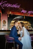 bride and groom inside a cocktail bar photo