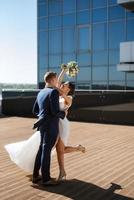 bride and groom first meeting on the roof of skyscraper photo