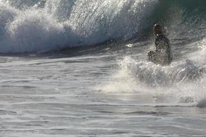 Surfers riding small ocean waves photo