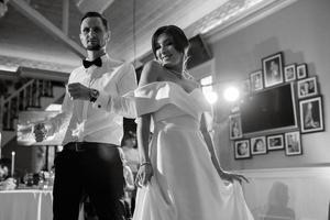 the first dance of the bride and groom inside a restaurant photo