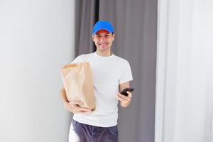 Paper container for takeaway food. Delivery man is carrying photo