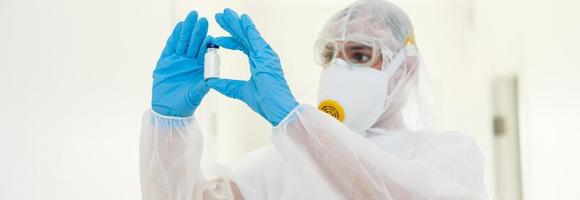 Man in protective clothing and a gasmask on a white background photo