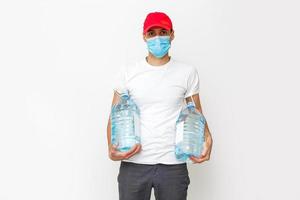 Strong water delivery man in protective mask. Isolated on white. photo