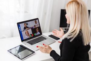 Teacher, tutor or professor with headset, laptop and camera in her office explaining something at an online lesson or video lecture, webinar photo