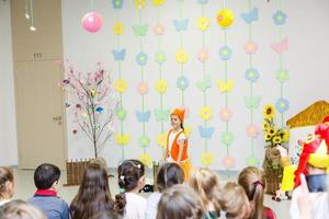 young actress in a fox costume speaking in front of children photo