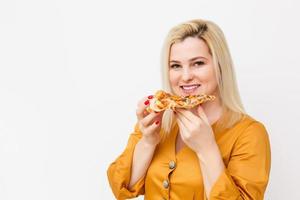 Happy young woman eating slice of hot pizza, isolated on white photo