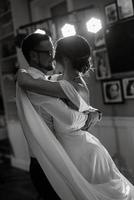 the first dance of the bride and groom inside a restaurant photo