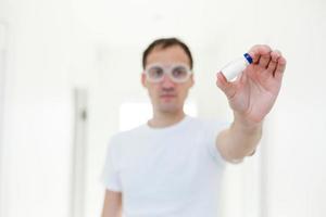 Taking decision. Focused photo on male hands that holding glass package with antivirus vaccine