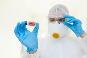 Taking decision. Focused photo on male hands that holding glass package with antivirus vaccine