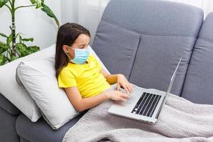 Coronavirus home school concept, quarantine. Girl doing homework. Modern lifestyle photo