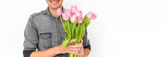 Man holding tulips. Gift card template, poster or greeting card - man holding bouquet of tulips for a woman. Mother's day, Valentine's day, Women's day concept. 8 of March gift photo