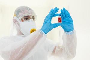 Man in protective clothing and a gasmask on a white background photo