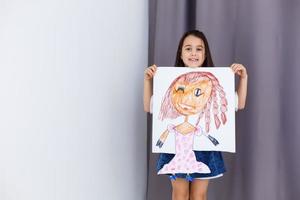 Little prescholer girl holding her portrait picture photo