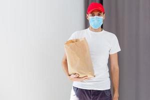 food delivery man in protective mask photo