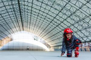 little girl on roller skates in city in spring photo