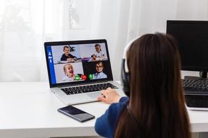 Pretty stylish schoolgirl studying homework math during her online lesson at home, social distance during quarantine, self-isolation, online education concept, home schooler photo