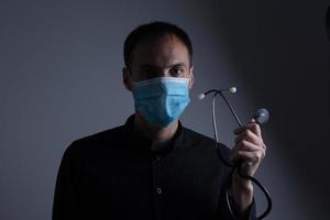 Strong man wearing mask to prevent flu virus and dust air pollution on white background photo