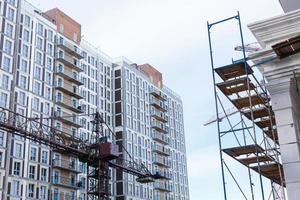 Extensive scaffolding providing platforms for work in progress on a new apartment block UK photo