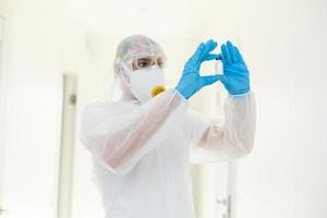 Man in protective clothing and a gasmask on a white background photo