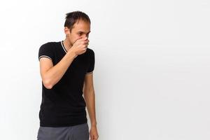 Close-up of a young man having a cough photo