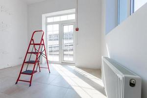 Office extension that uses bricks as a wall, construction, improvement. Interior of small room with window and bricks walls renovation, extension, overhaul and reconstruction. photo