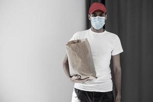 food delivery man in protective mask photo