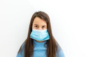 Asian Little Chinese Girl Wearing a Protective Mask in Isolated White Background. photo