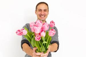 Man holding tulips. Gift card template, poster or greeting card - man holding bouquet of tulips for a woman. Mother's day, Valentine's day, Women's day concept. 8 of March gift photo