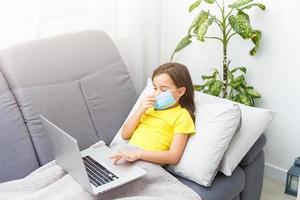 Coronavirus home school concept, quarantine. Girl doing homework. Modern lifestyle photo