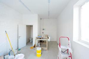 Small apartment without repair in a new building. A room in an unfinished house. Walls of foam block and concrete floor in a tiny apartment. photo