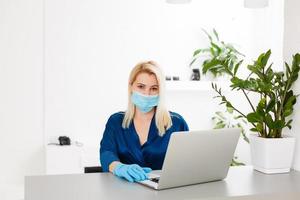 Woman in quarantine wearing protective mask and smart working photo